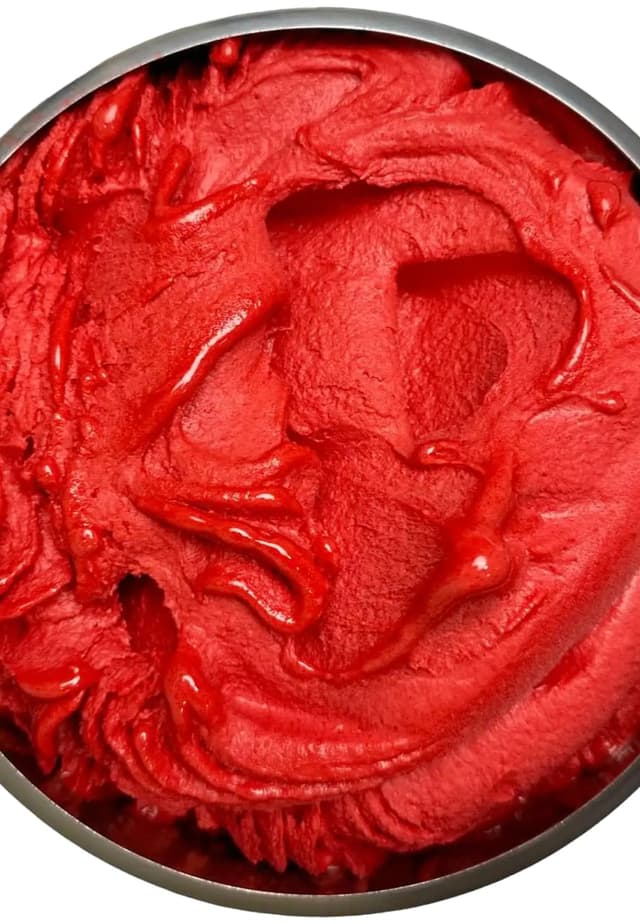 Deep red sour cherry sorbet swirled in a metal pan