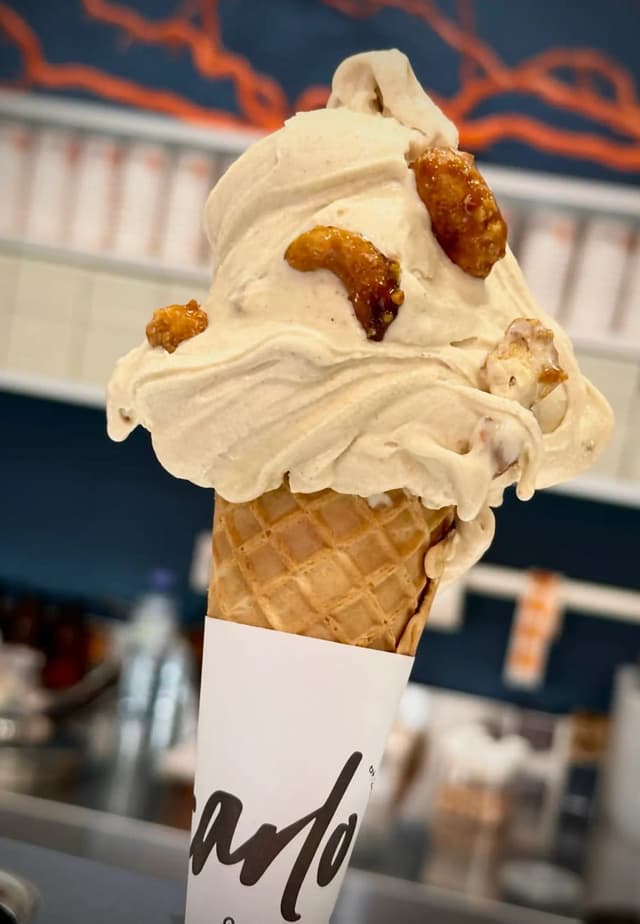 Caramel gelato cone topped with caramelised nut clusters